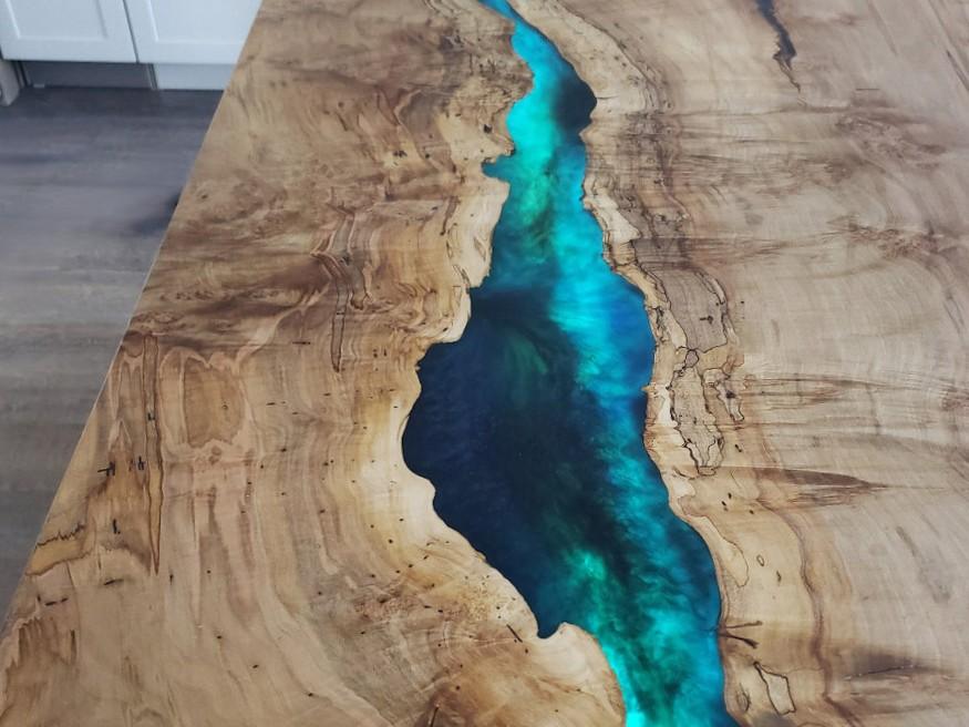 Maple kitchen island with a turquoise epoxy river, built by Makers Woodshop