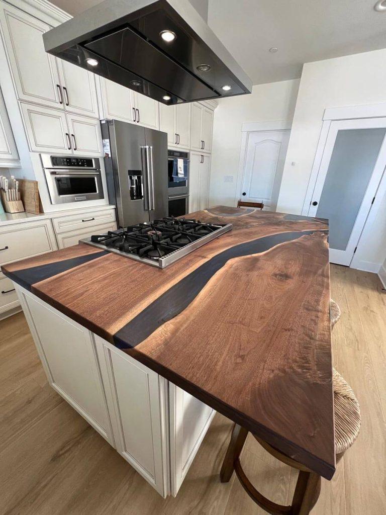 Black walnut and epoxy kitchen island top by Makers Woodshop